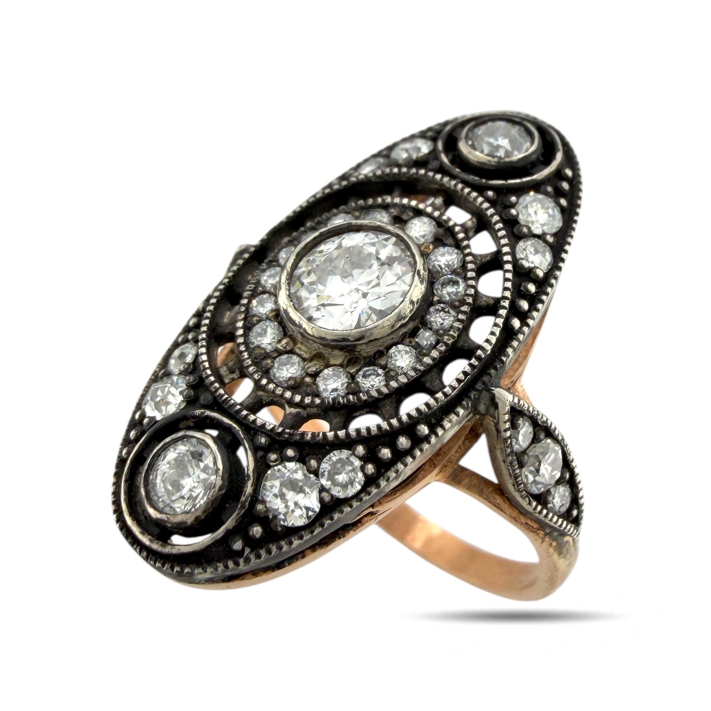 Antique diamond ring with oval center stone, black filigree bezel and side stones