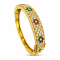 Hinged yellow gold cuff bracelet with diamond pave and sapphire, ruby, emerald accents