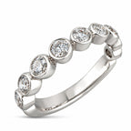 White gold diamond band with evenly spaced round diamonds in bezel settings