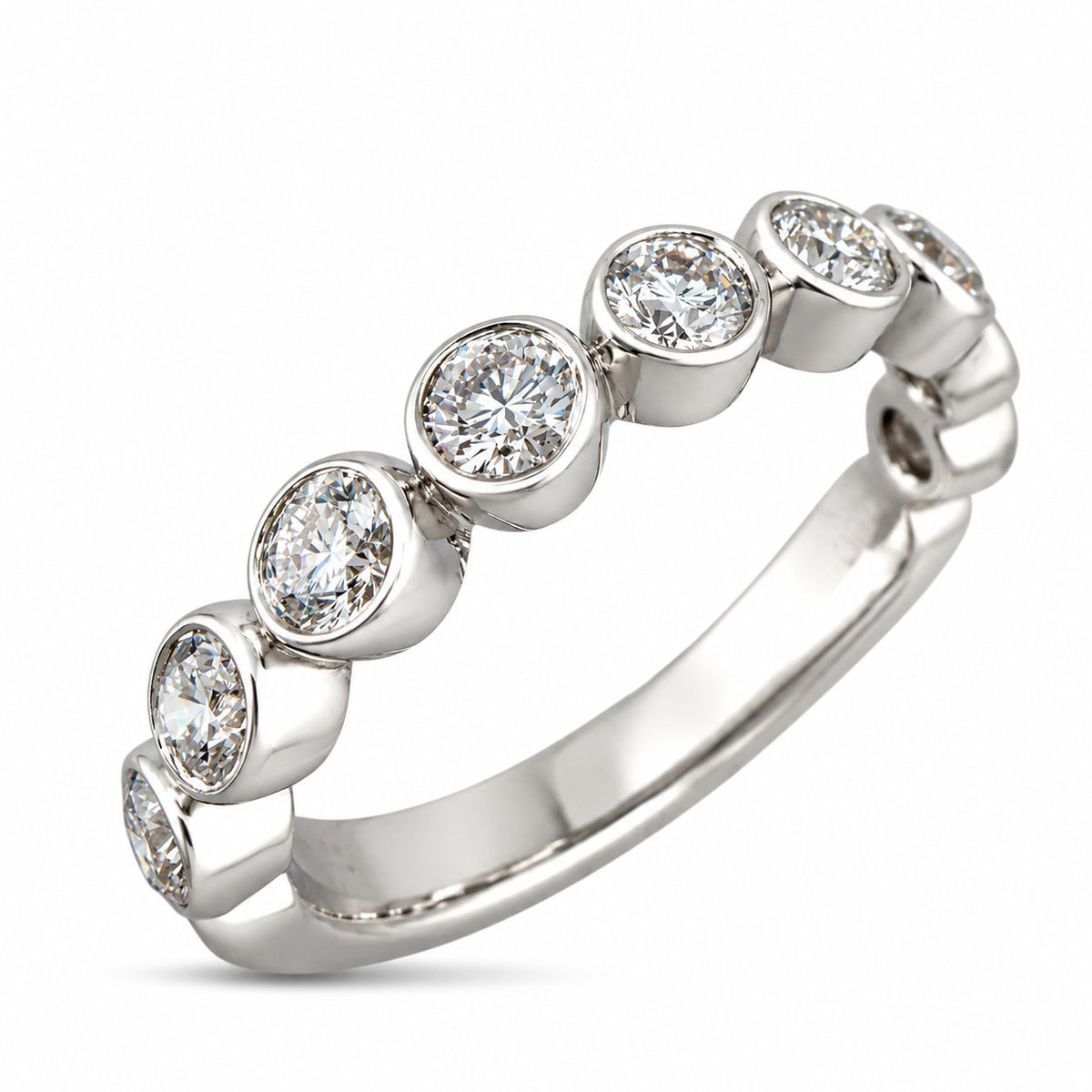White gold diamond band with evenly spaced round diamonds in bezel settings
