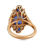 Back view gold ring with filigree design and small blue stone accents