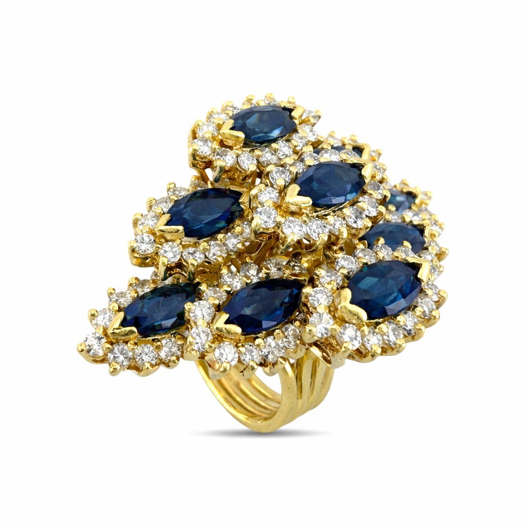 18K yellow gold cocktail ring with oval blue sapphires surrounded by round diamonds