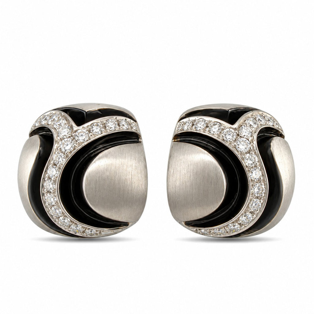 Pair of sculpted 18K white gold earrings with curved diamond-set bands