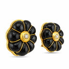 Angled pair of sculpted onyx clip-on earrings with gold trim and diamond centers