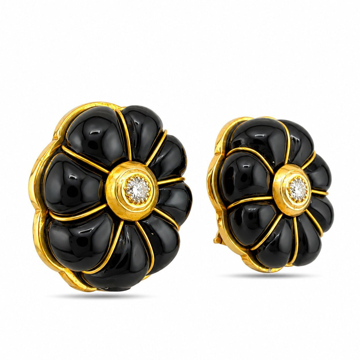 Angled pair of sculpted onyx clip-on earrings with gold trim and diamond centers