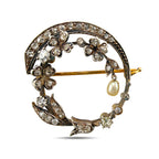 Rose gold floral brooch with diamonds, a pearl drop, and a curved diamond-set frame