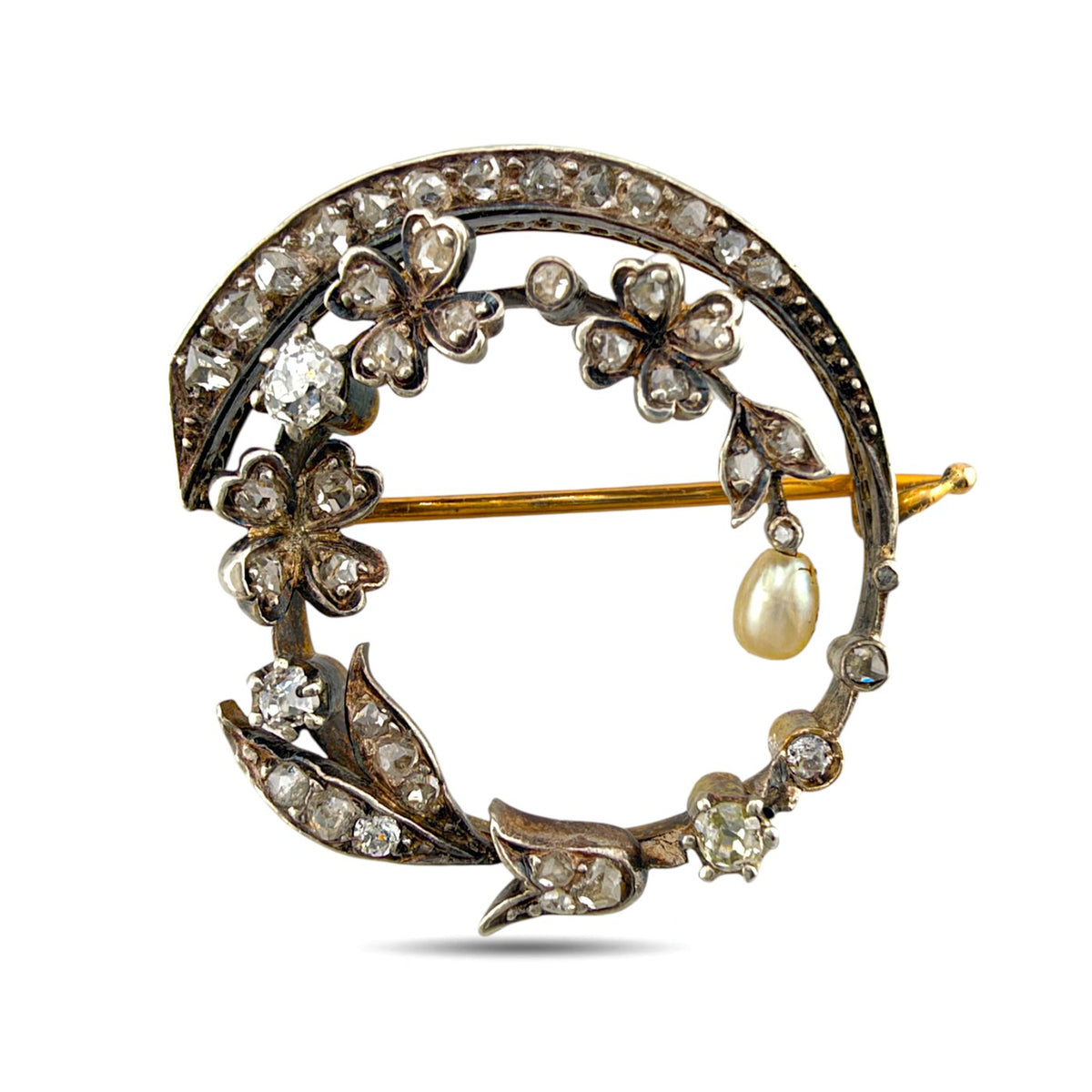 Rose gold floral brooch with diamonds, a pearl drop, and a curved diamond-set frame
