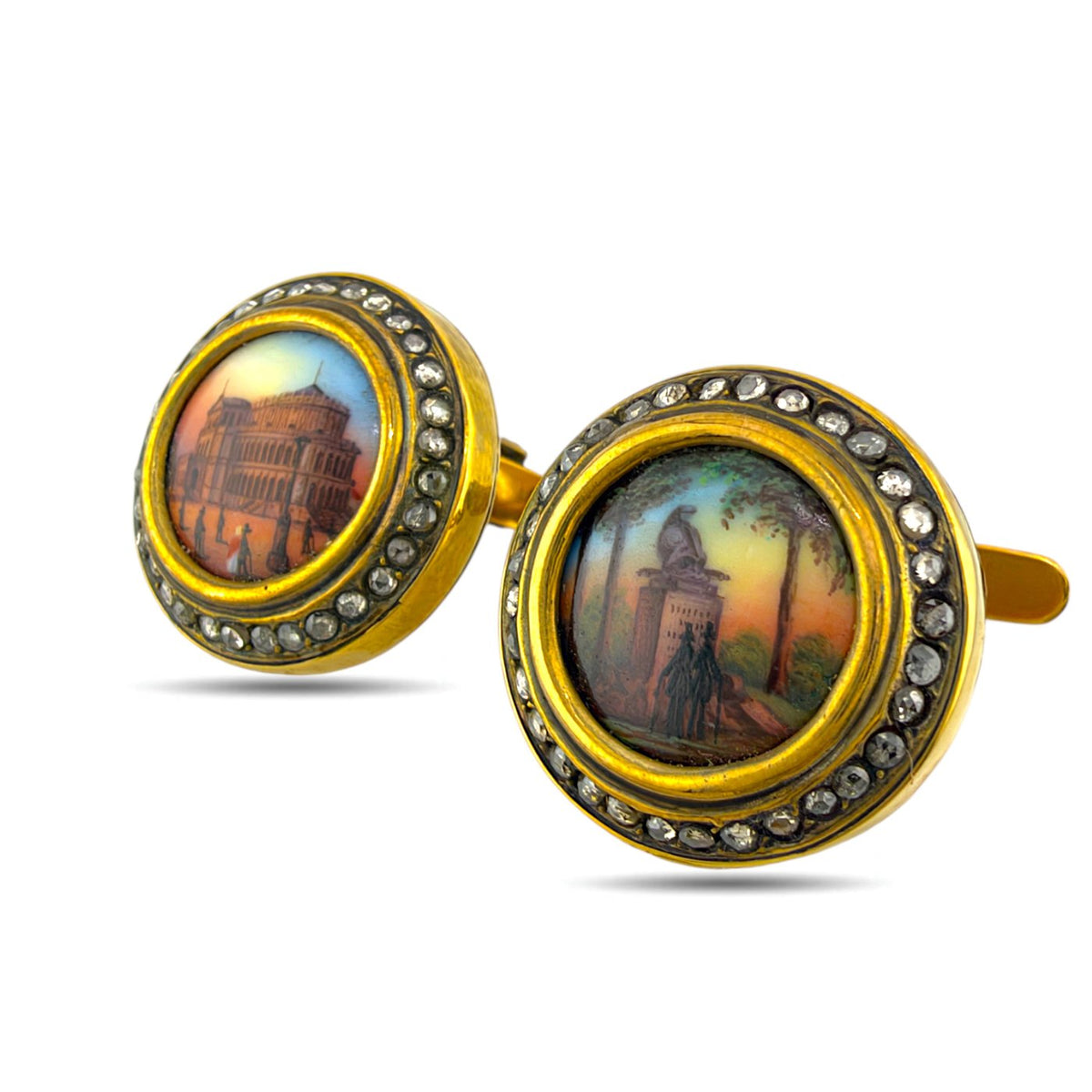 Gold cufflinks with scenic enamel faces and diamond-set rims, shown at an angle
