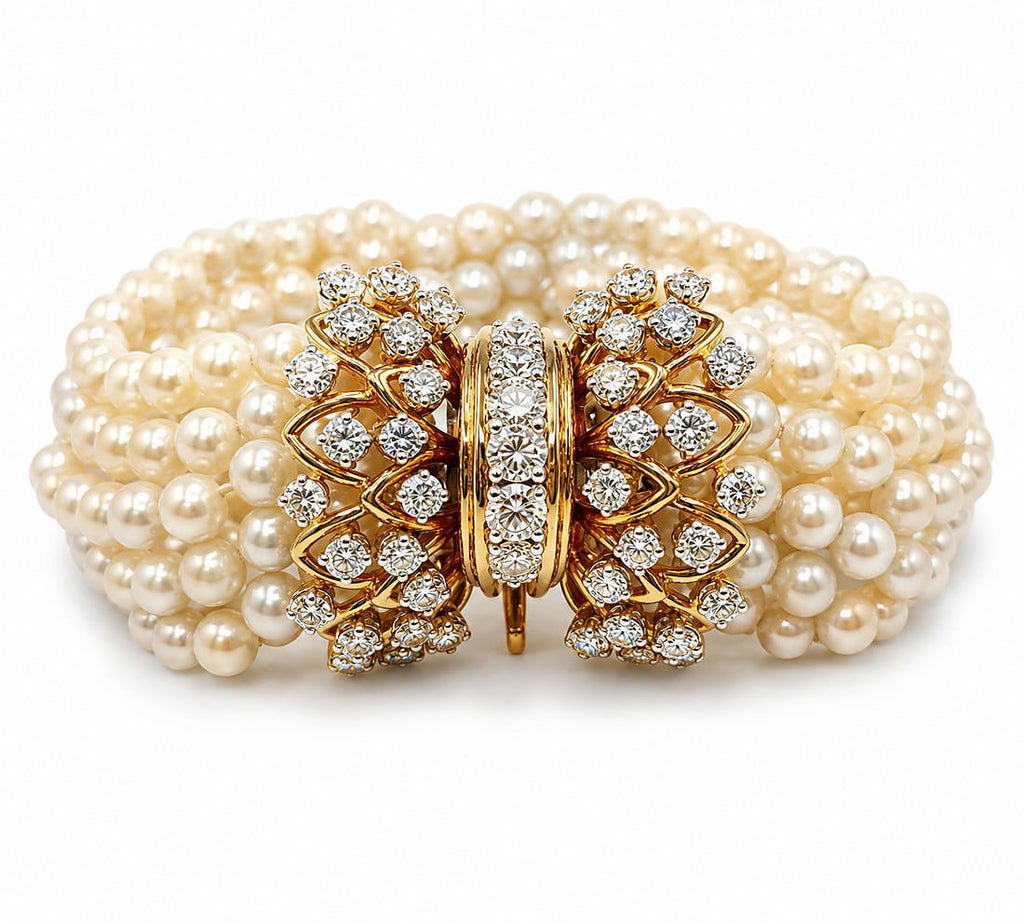 Multi-strand pearl bracelet with yellow gold diamond clasp and ornate floral motif