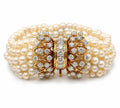 Multi-strand pearl bracelet with yellow gold diamond clasp and ornate floral motif