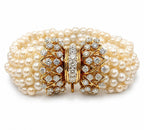 Multi-strand pearl bracelet with yellow gold diamond clasp and ornate floral motif