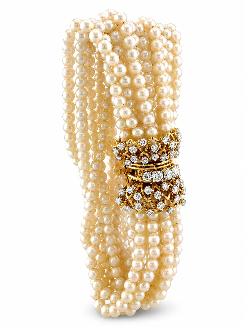 Multi-strand pearl bracelet with yellow gold diamond clasp, wide cuff profile