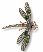 Dragonfly brooch with green oval enamel centers and clear rhinestone wings, gold tone