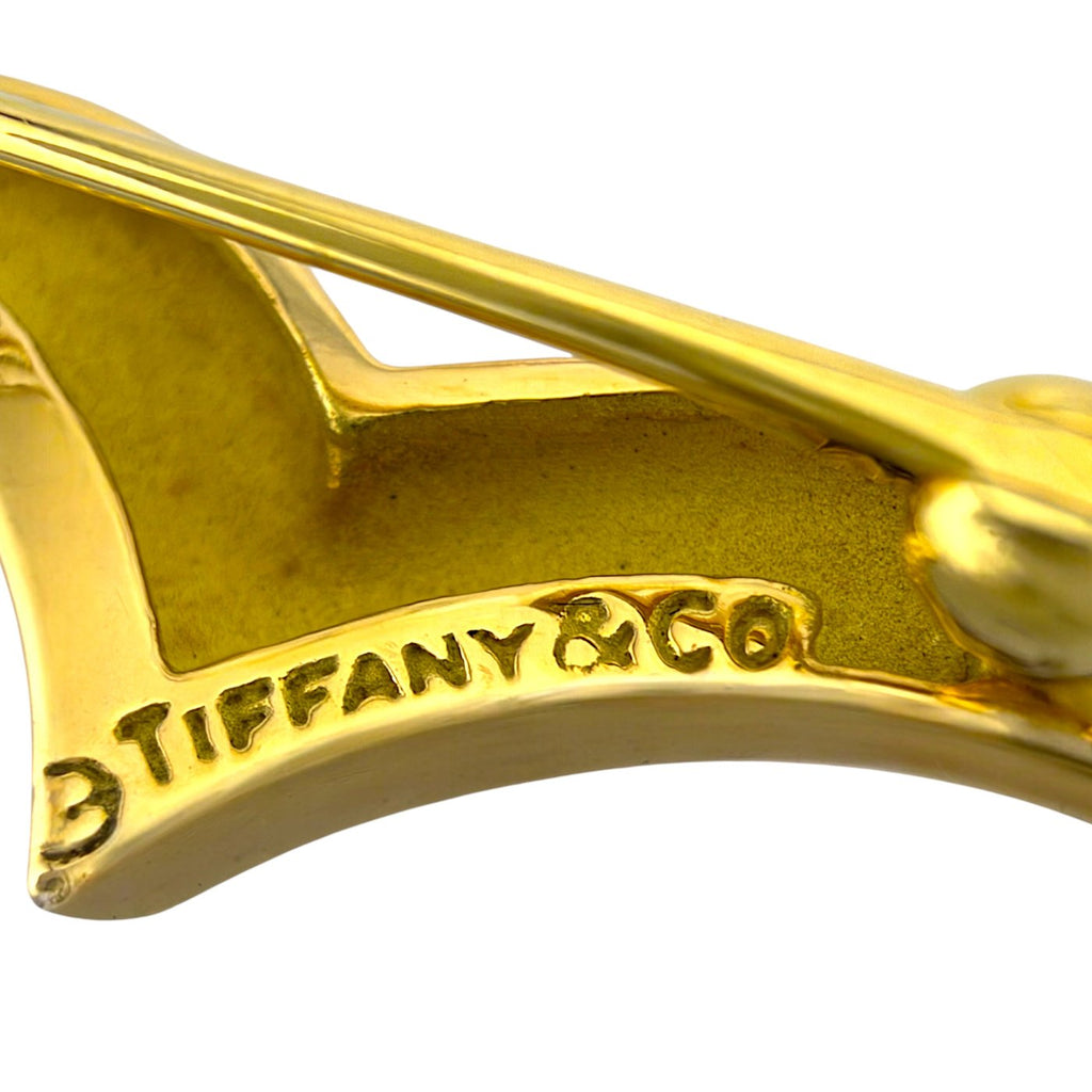 Close-up of yellow gold swan brooch engraving "TIFFANY&CO 1860"