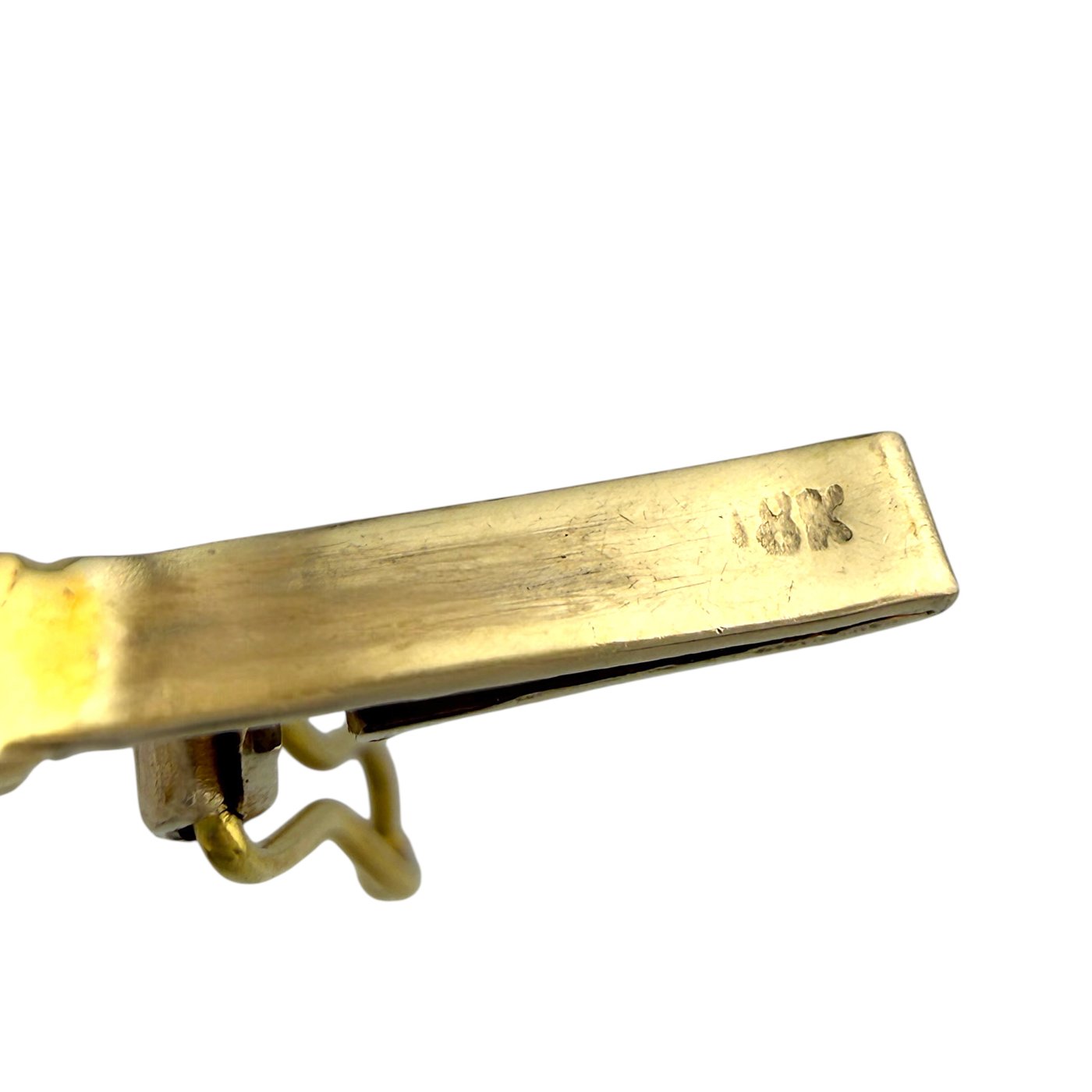 Gold bracelet end with stamped markings on the clasp bar