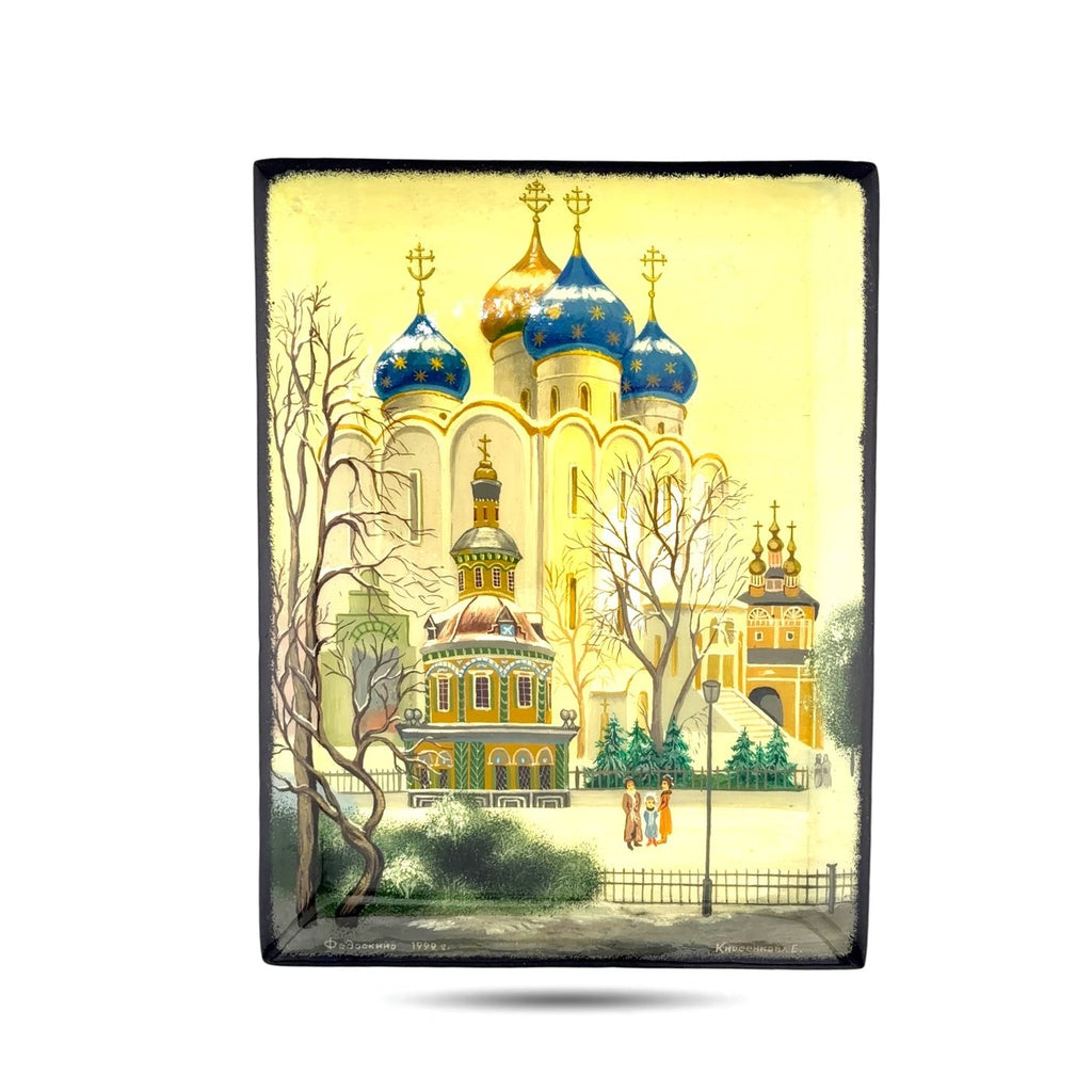Black lacquer trinket box with colorful church scene on lid, closed view