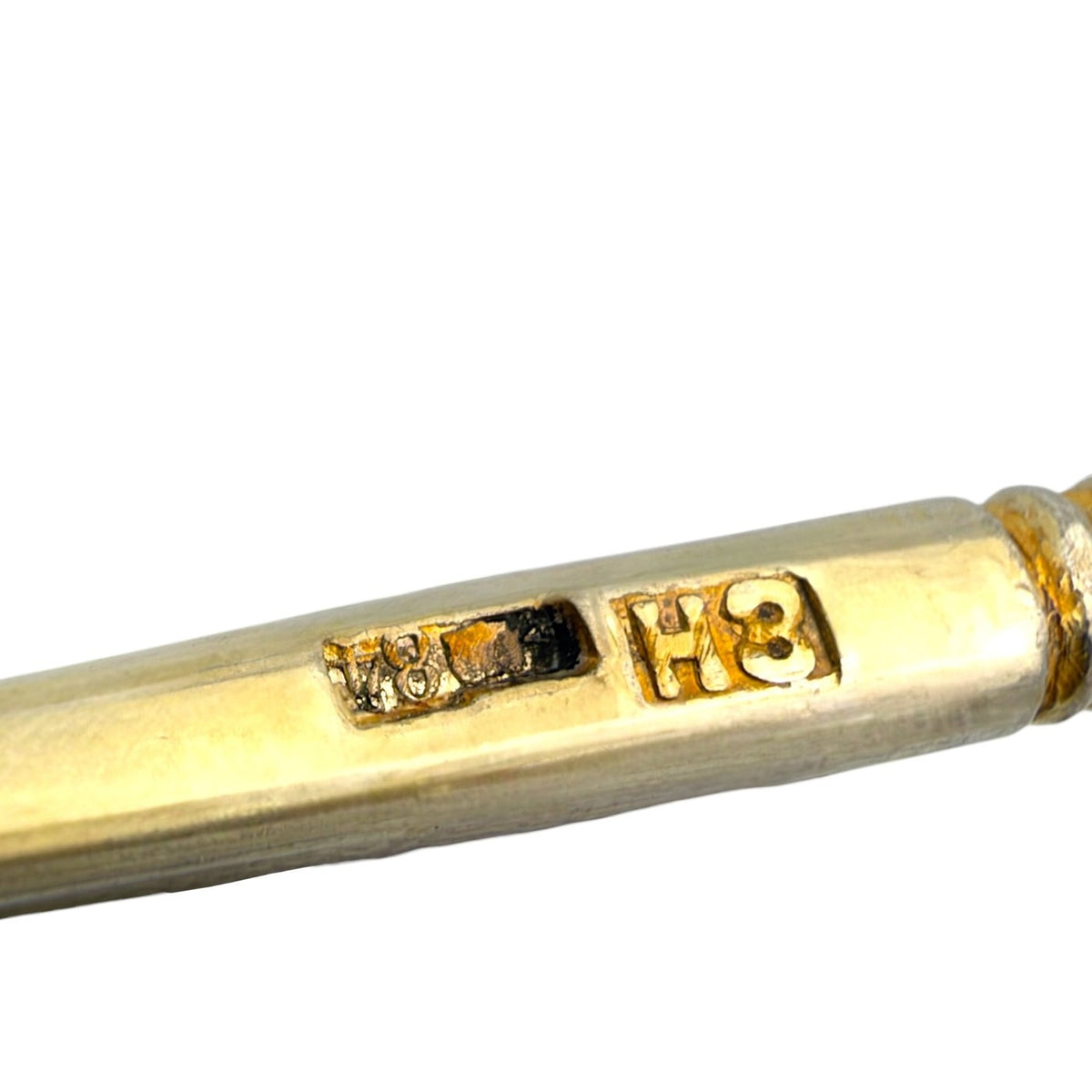 Spoon handle closeup with engraved '78' and '84' marks near the ferrule