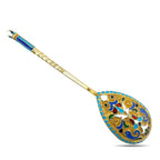 Decorative enamel serving spoon with blue and gold floral pattern, ornate handle
