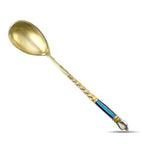 Gilded metal spoon with rounded gold-toned bowl and rope-twist handle