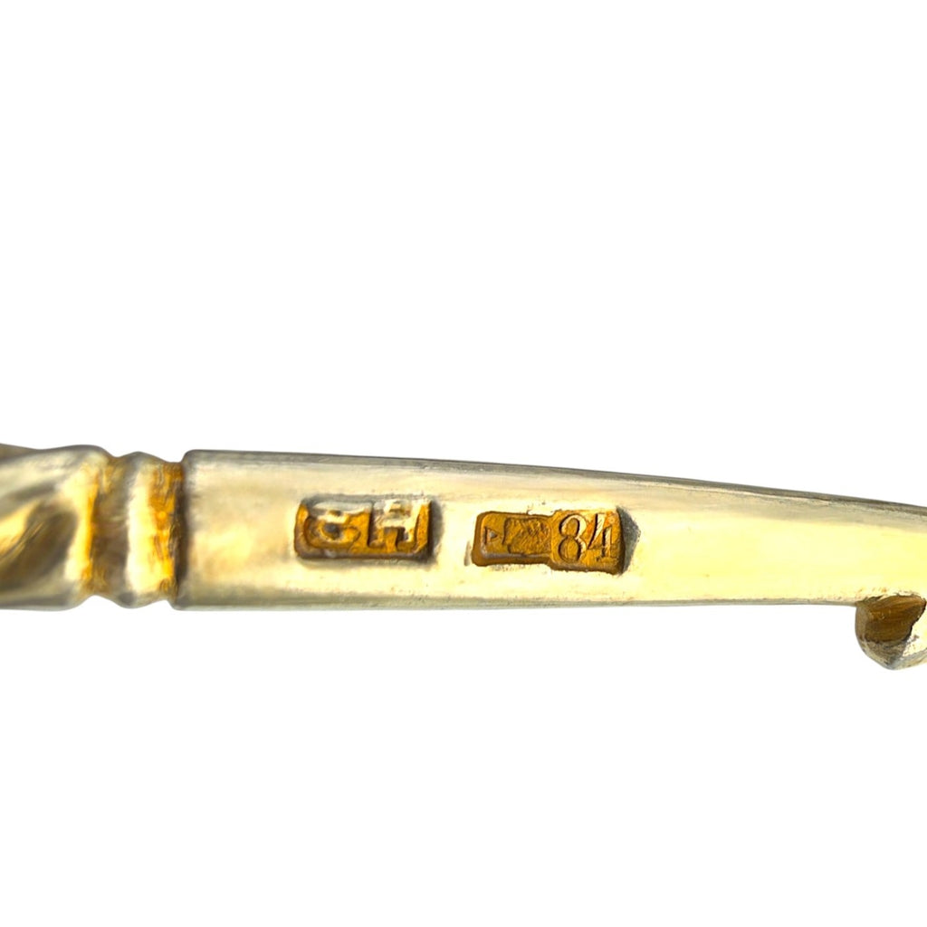 Silver-tone spoon handle closeup showing '84' zolotnik hallmark engraving