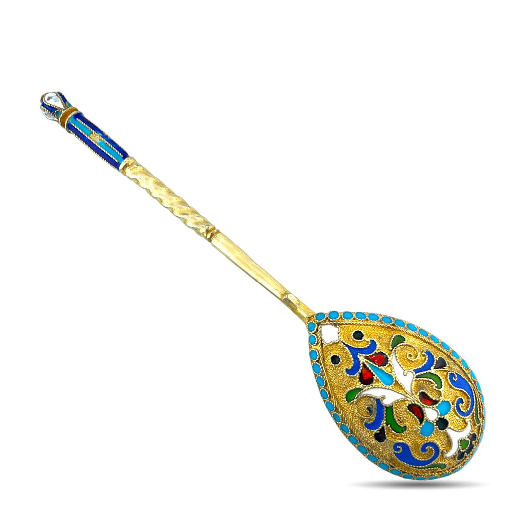 Gilded enamel spoon with blue band at end and ornate blue-and-gold teardrop bowl