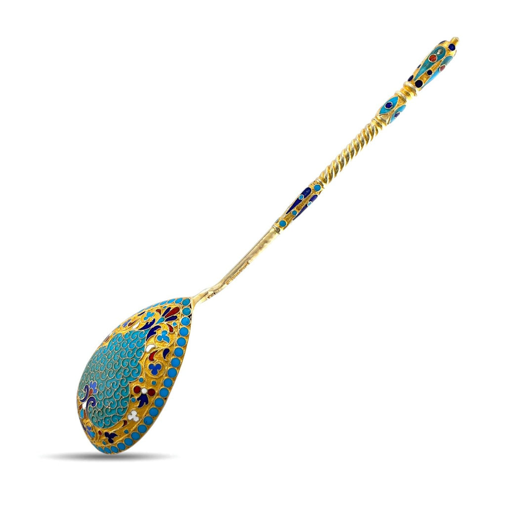 Antique enamel serving spoon with blue and gold oval bowl and ornate handle