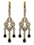Gold tone chandelier earrings with white diamonds and blue teardrop enamel drops