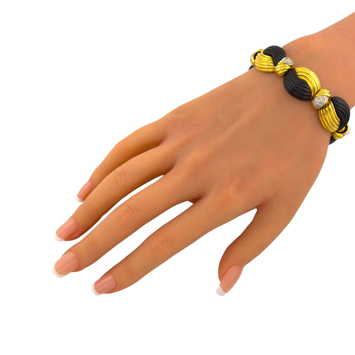 Angled view of the gold and black onyx bracelet worn on the wrist