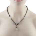 Diamond bead necklace with dark round stones and small pavé sphere drop pendant
