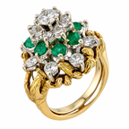 Front angle of yellow gold ring with round diamonds and green emerald clusters