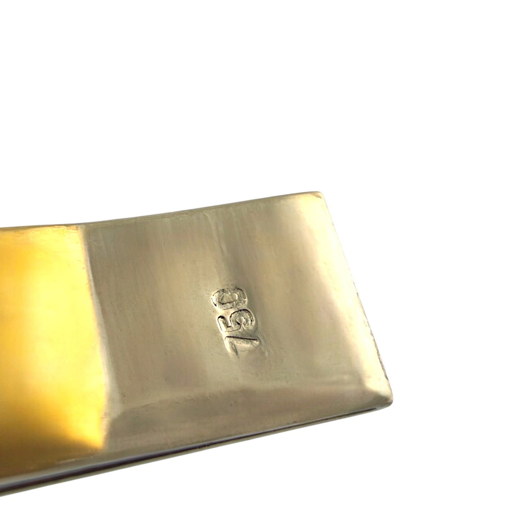 18K gold bracelet clasp close-up with a stamped 18K mark