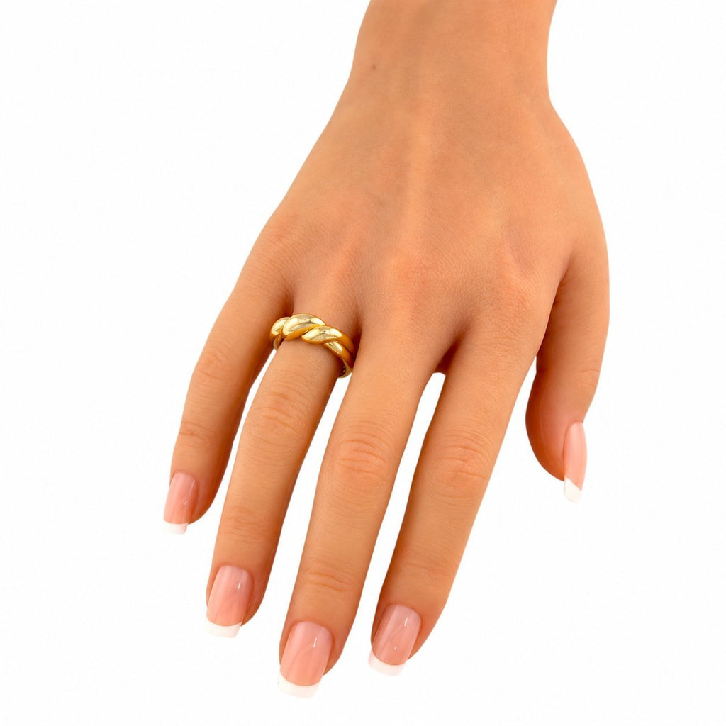 18K yellow gold sculptural ring on finger with rounded twist detail