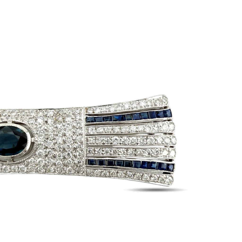 Diamond bar brooch close-up: blue sapphire stripe panel with partial oval blue center stone