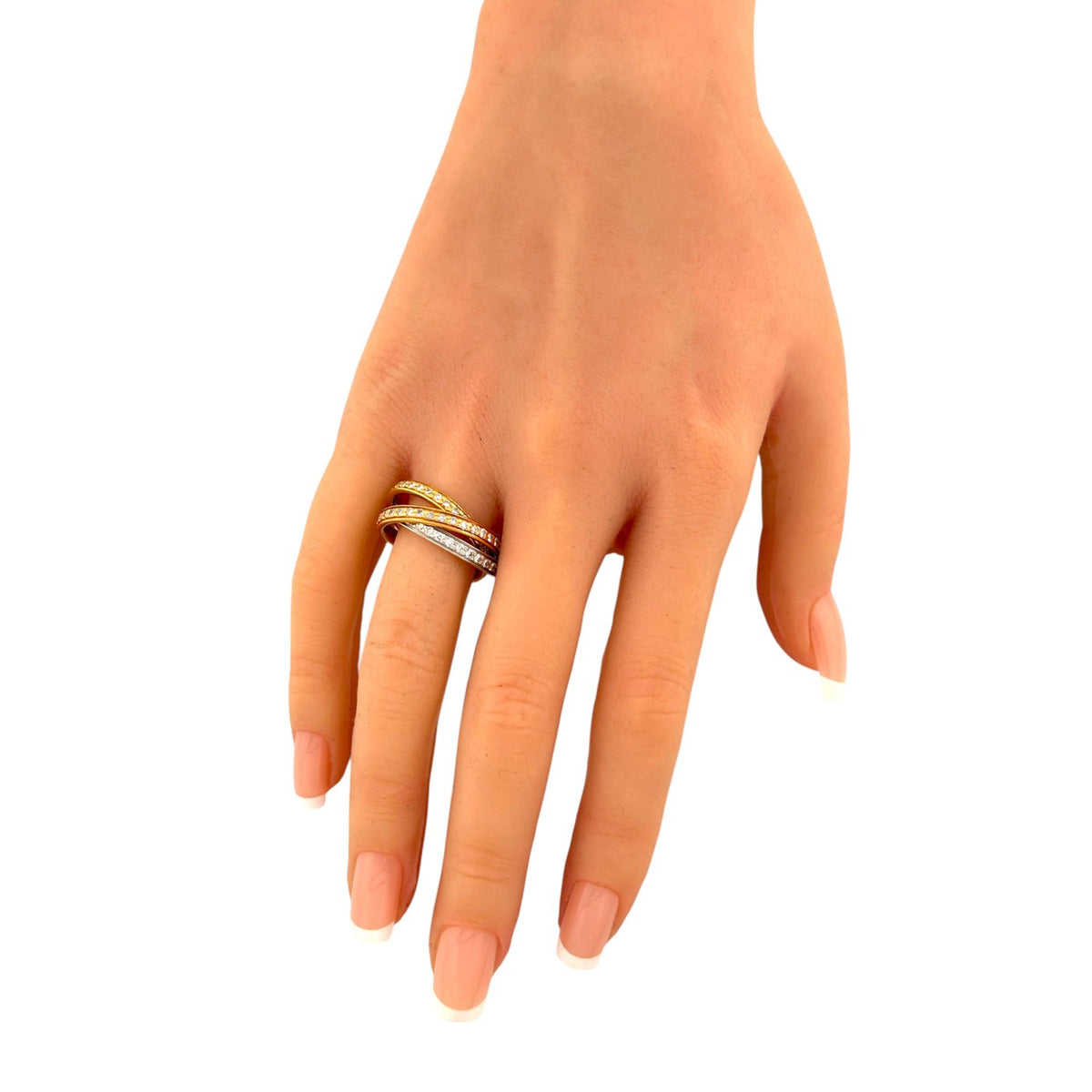 Three-tone gold ring with diamond-set bands shown on a hand