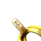 Close-up of gold tone clasp with engraved maker mark on link