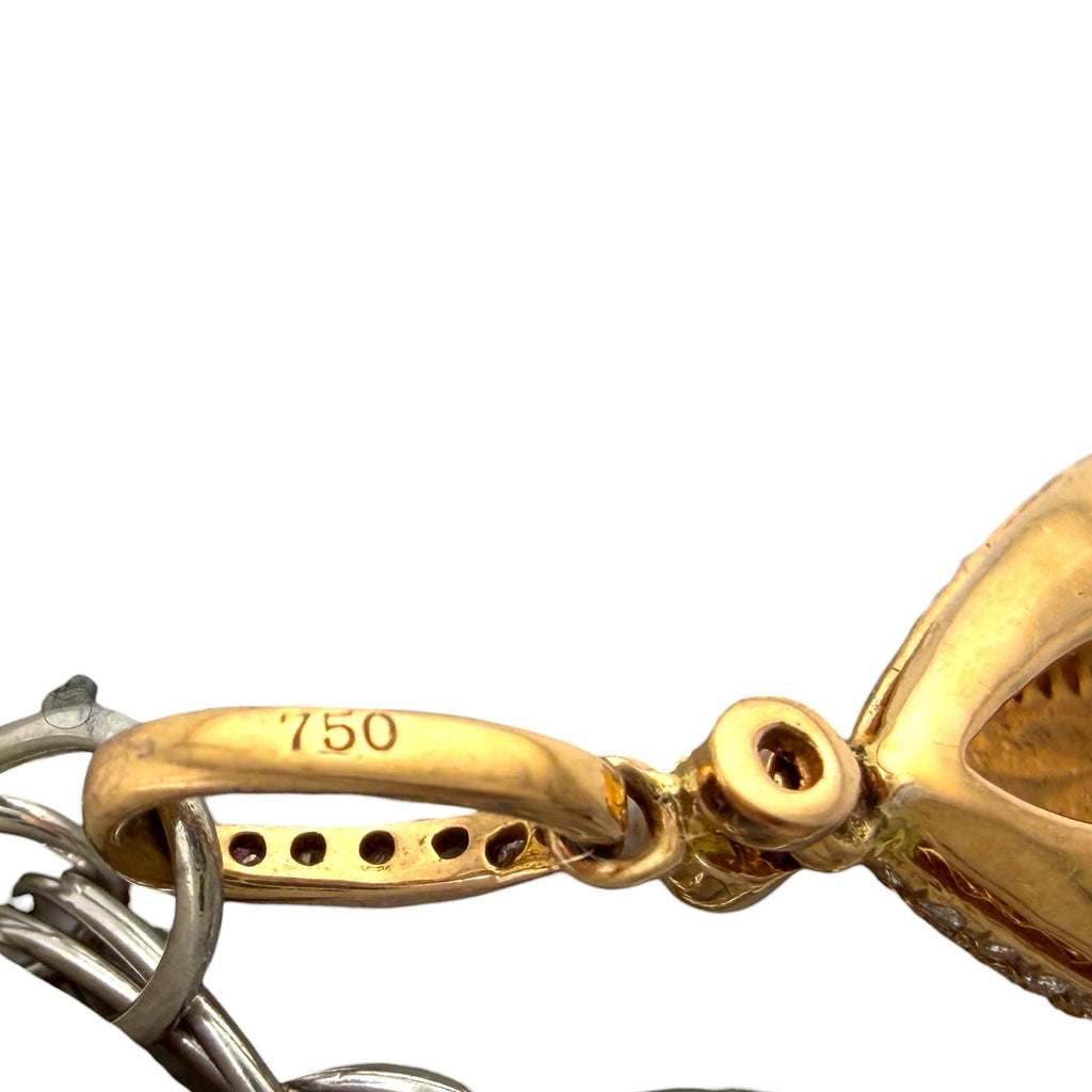 Gold clasp component marked 750 on a silver-and-gold bracelet link