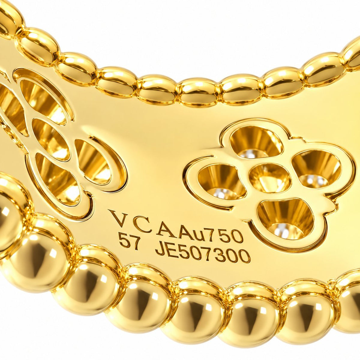 Van Cleef & Arpels ring interior with gold clover cutouts and 18K hallmark