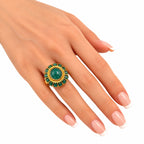 14K yellow gold jade cabochon ring on finger with green oval centerpiece