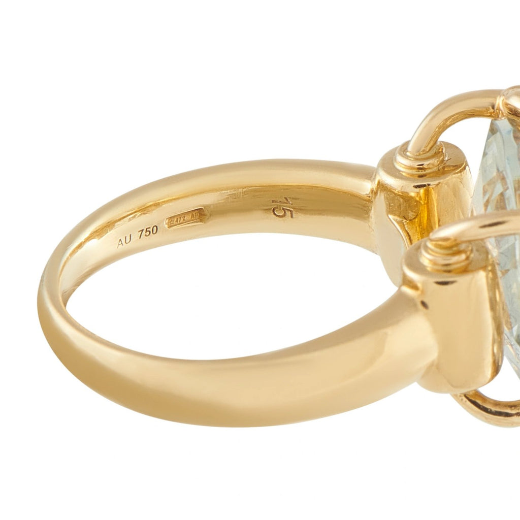 Yellow gold band close-up with AU 750 hallmark and horsebit-style setting