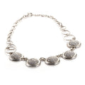 Platinum and diamond pave necklace with five oval bezel stations on a chain