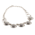 Platinum and diamond pave necklace with five oval bezel stations on a chain