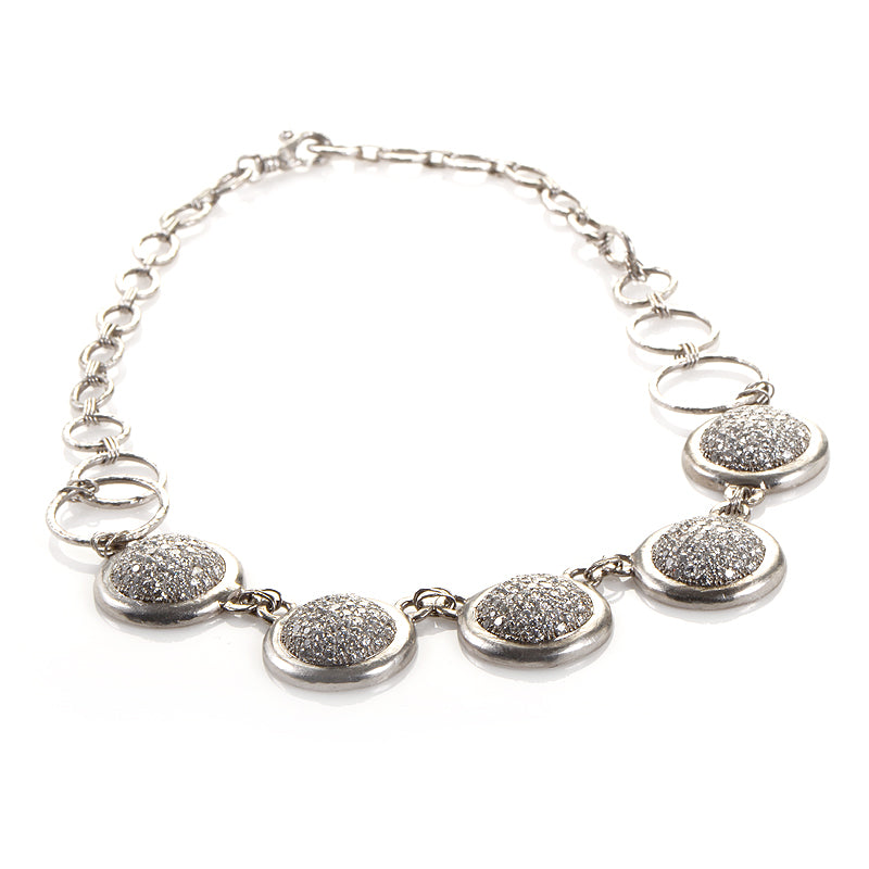 Platinum and diamond pave necklace with five oval bezel stations on a chain