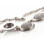 Platinum diamond pave necklace close-up of oval pave stations and linked clasp