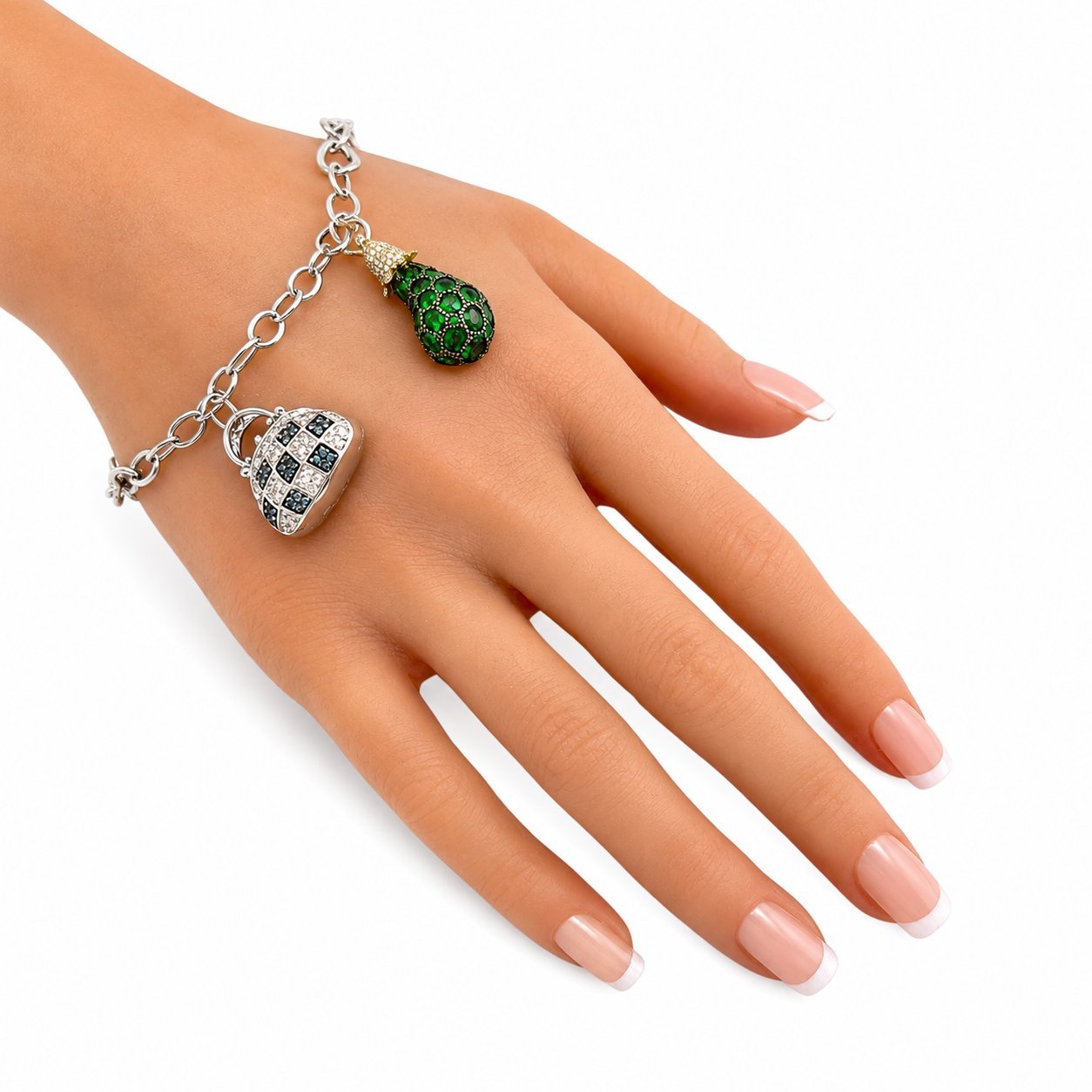 Charm bracelet on wrist with green teardrop and blue diamond-pattern heart pendants