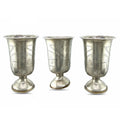 Antique silver tone cup set, three engraved goblets with flared rim and pedestal base.