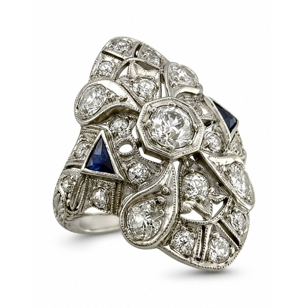Art Deco diamond and sapphire ring with round center stone and ornate filigree, platinum-tone