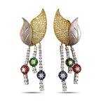Gold-and-silver floral dangle earrings with pavé petals, leaf accents, and gemstone tassels