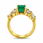 Yellow gold ring with square green emerald center and white diamond side stones
