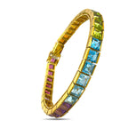 18K yellow gold rainbow gemstone tennis bracelet with rectangular stones in an upright oval