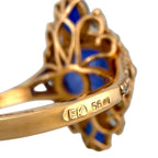 Rose-gold ring band close-up with hallmark engraving and number 56